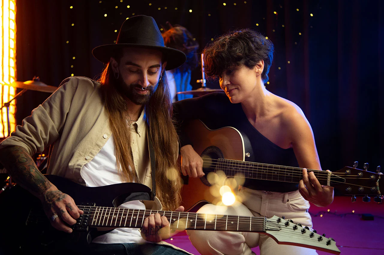 Two musicians jamming with guitars on stage